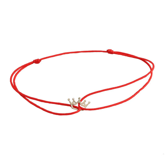 Bracelet with a 14K solid gold crown pendant on a silk cord