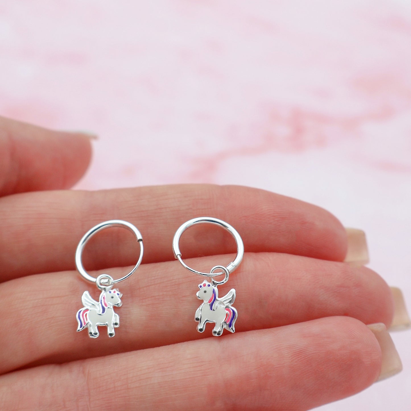 Round drop earrings with a pink and purple unicorn