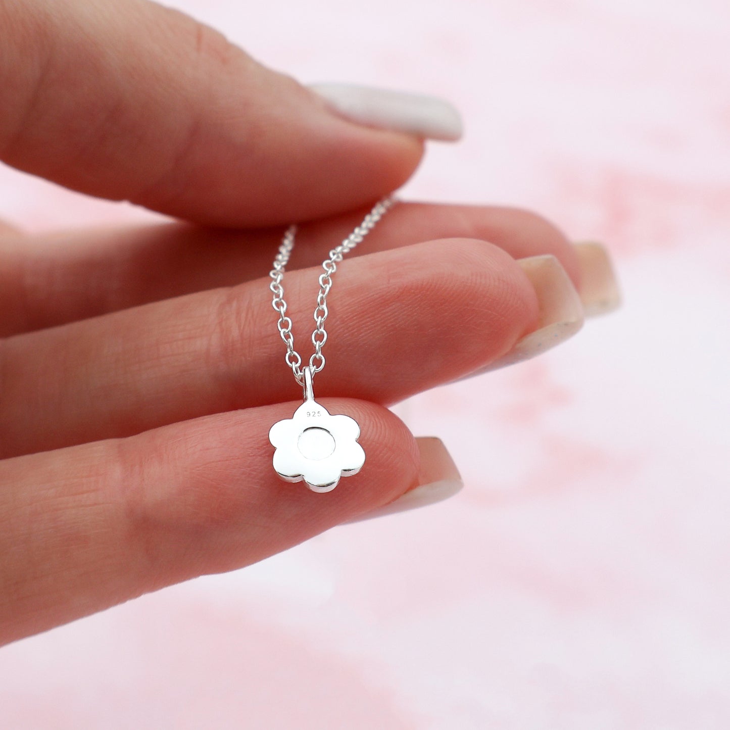 Necklace featuring a smiling flower pendant with multicolored petals