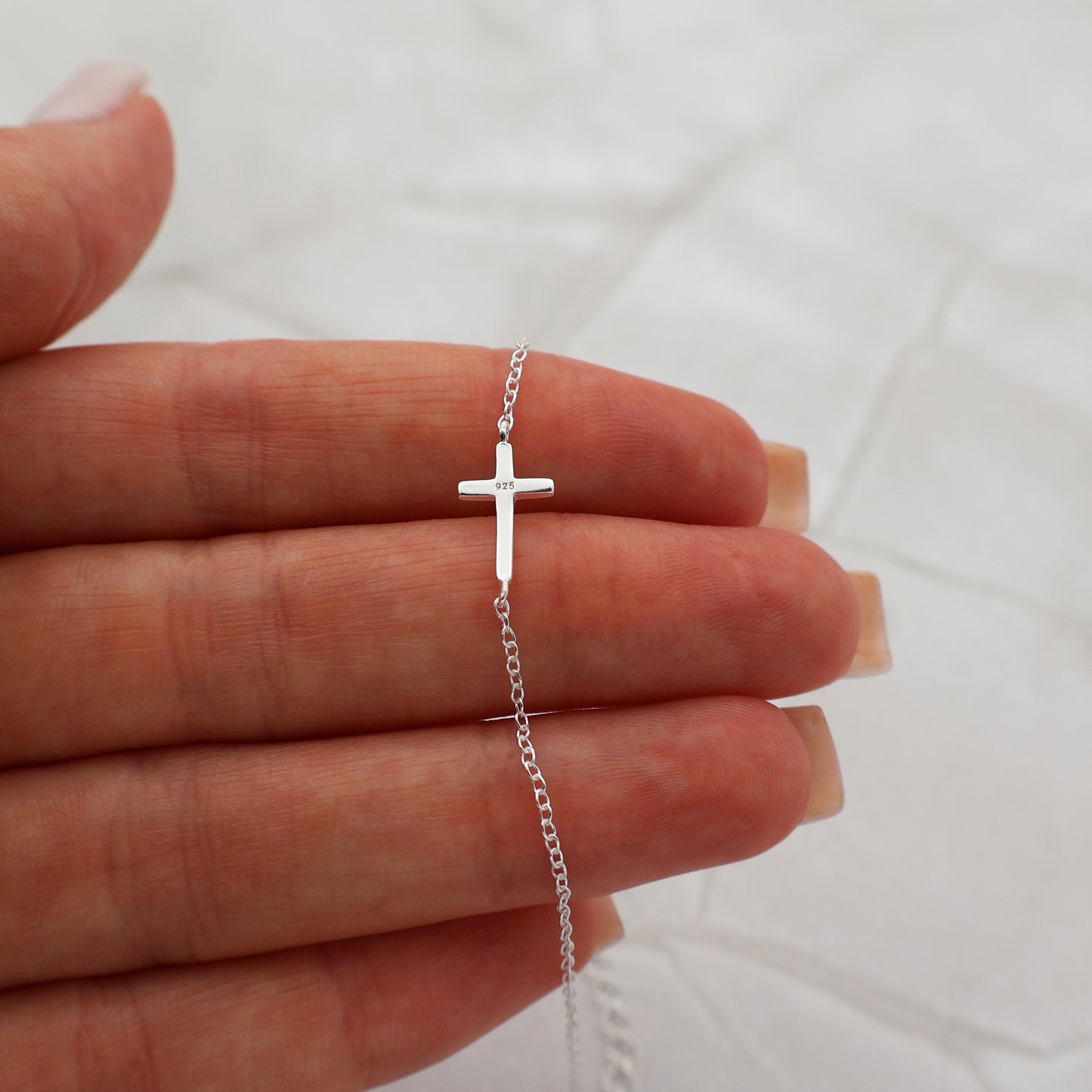 Bracelet with a simple fixed cross pendant