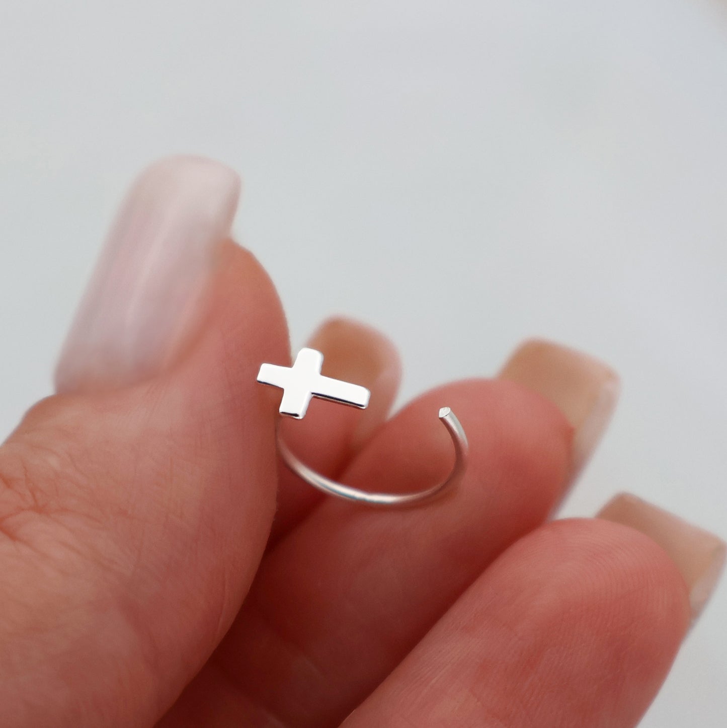 Half-hoop earrings with a small cross