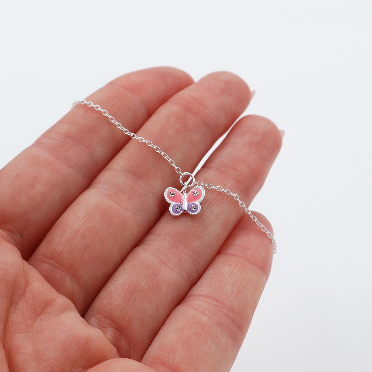 Bracelet featuring a pink and purple butterfly with 4 white crystals