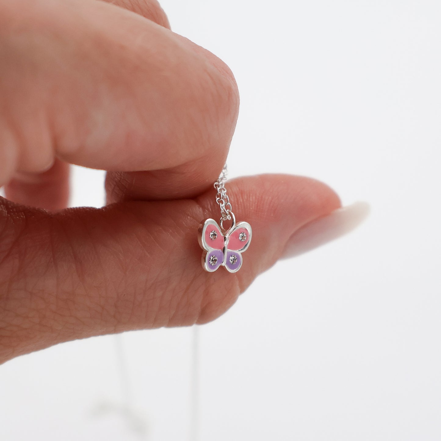 Necklace featuring a pink and purple butterfly with 4 white crystals